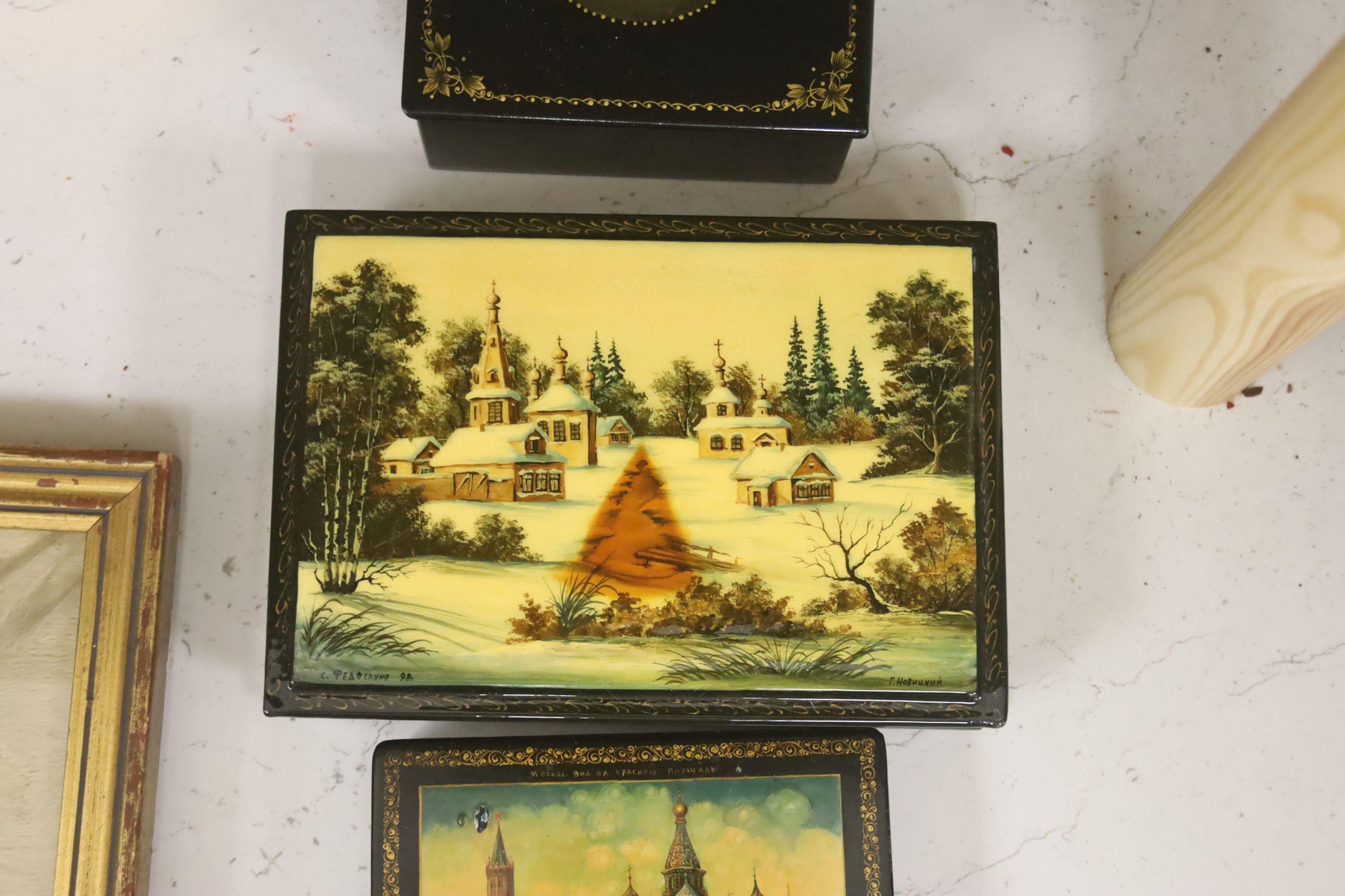 Six Russian Papier mache boxes, each decorated with churches or cathedrals, largest 17 cm